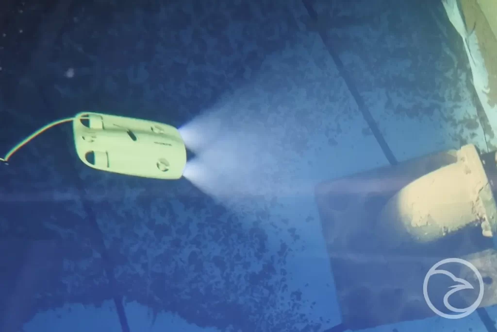 Operator controlling ROV drone during confined space inspection