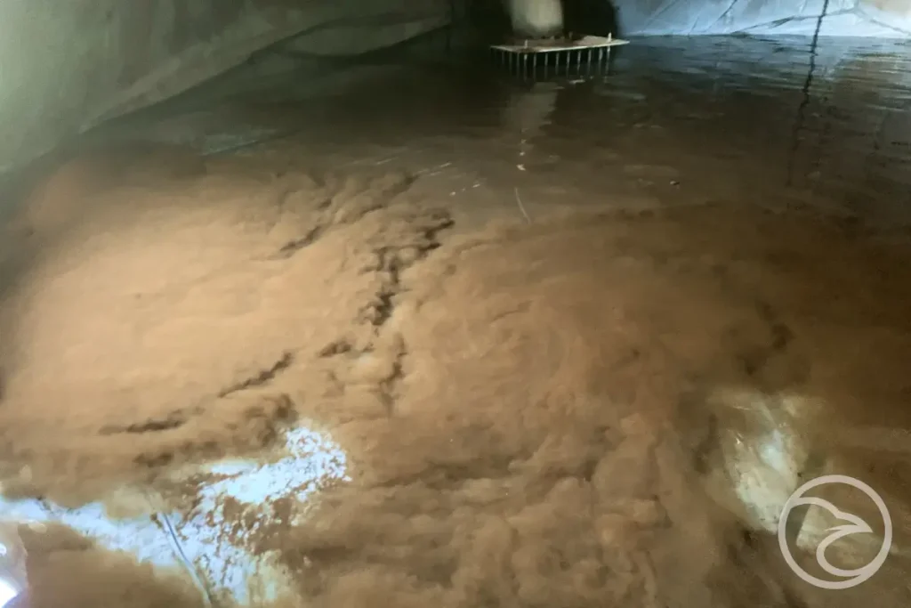 Sediment buildup at the bottom of a water tank affecting system performance