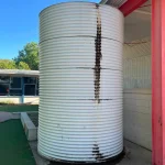 damaged fire tank wall with visible structural defects